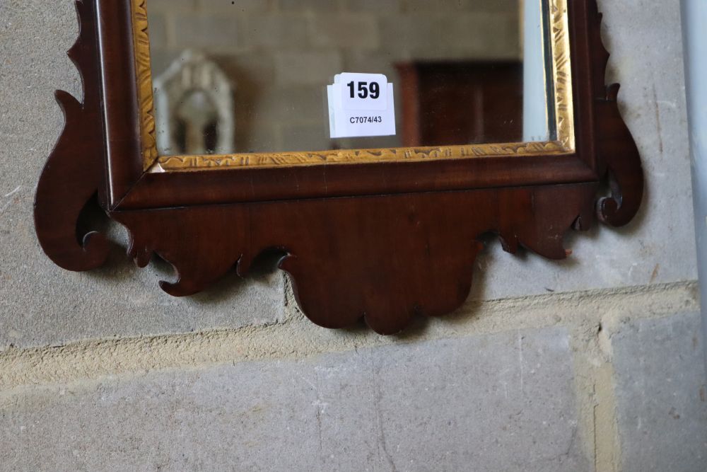 A small George III style mahogany fret cut wall mirror, width 40cm, height 70cm